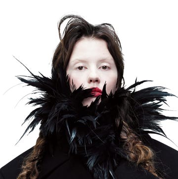 mia goth. coat, feather bodysuit, balenciaga couture.