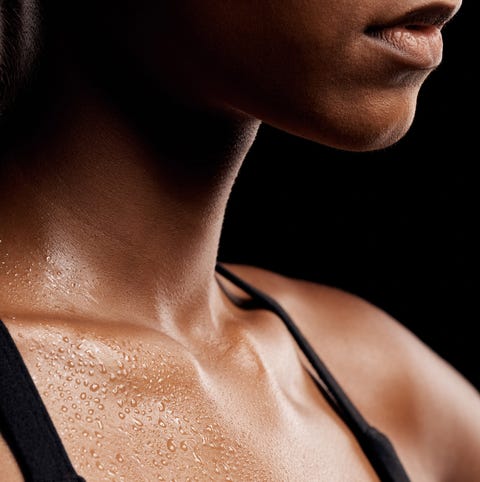 fitness, sweat and chest of a woman in a studio after an intense workout or sport training. sports, health and healthy female athlete sweating after a health gym exercise by a black background.